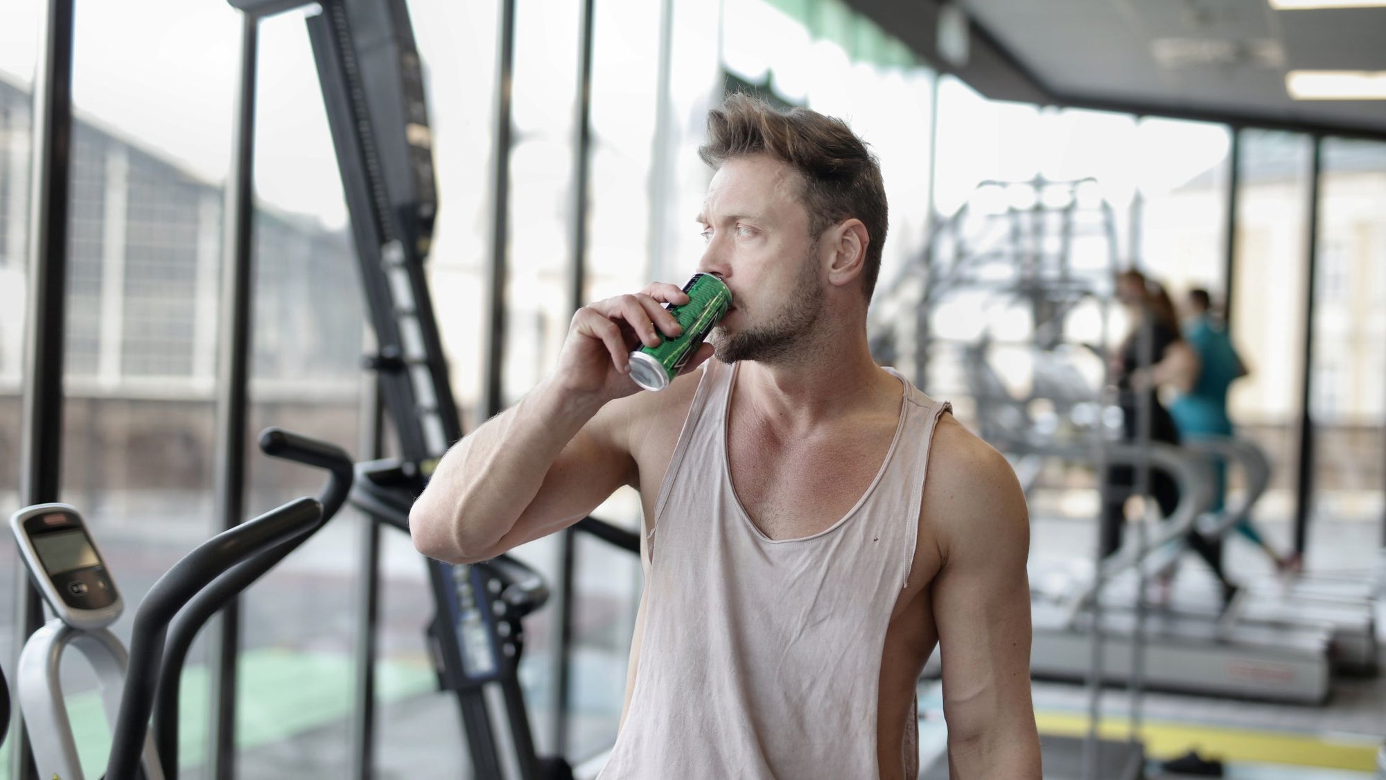 Man drinking an energy drink for working out